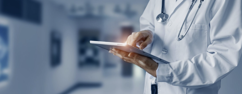 Doctor holding a tablet and interacting with it.